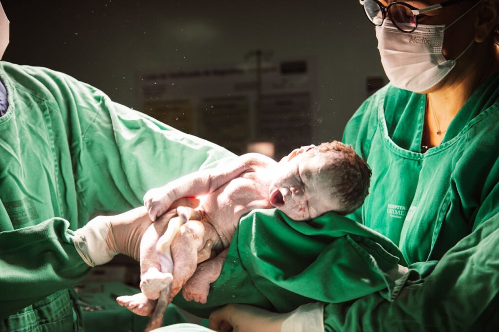 Doctors Holding a Newborn Baby During Labor